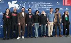 The Venice film festival jury line up with three wearing T-shirts in support of striking writers.