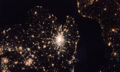 A nighttime view of Western Europe is captured by crew members aboard the International Space Station. The bright city of London is visible in the center of the image, photographed from over 250 miles above