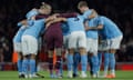 Manchester City players in a huddle just before kick-off against Arsenal in February 2023 at the Emirates