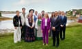 Eleven people, some in traditional Norwegian garb, by the waterside in Norway