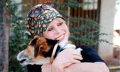 Brigitte Bardot holding a dog in her arms