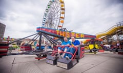 Two men ride the Twister ride at Dreamland amusement park in Margate, Kent.