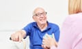 Smiling senior with a mug of coffee being cared for in home care<br>Social care. Smiling senior with a mug of coffee being cared for in home care