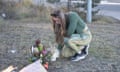 A woman places flowers at the site of the deadly bus crash in the Hunter Valley