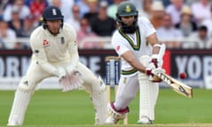 South Africa’s Hashim Amla sweeps on the third day of the second Test, watched by England’s Jonny Bairstow who failed to review a catching chance early in the day.