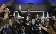The Greek prime minister and leader of the New Democracy party, Kyriakos Mitsotakis, salutes party supporters
