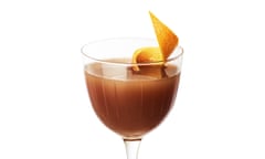 A tangy chocolatini in a tall, thin-stemmed glass with a twist of orange peel resting in it