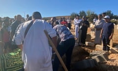 People attend the funeral of Bilal Kissi.