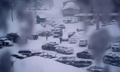 Snow on top of multiple cars and on the ground and roofs.