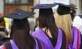 Three students dressed in gown and mortarboard