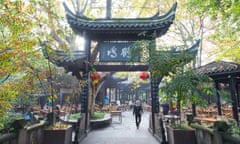 People's park famous HeMing teahouse main gate<br>Chendu, China - Nov 1, 2017 : People's park famous HeMing teahouse main gate with sunrays passing thought trees on a hazy day.