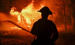 silhouette of fire fighter against flames