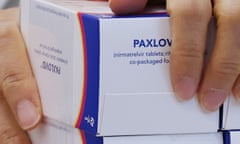 A pharmacist checks boxes containing Paxlovid