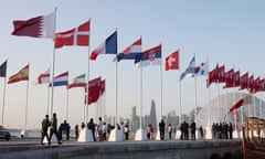 The flags of qualifying nations are raised along the Doha Corniche.