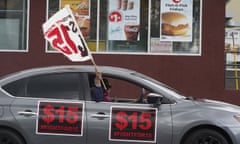 FILE - Fast-food workers drive though a McDonald's restaurant demanding a for a $15 hourly minimum wage in East Los Angeles Friday, March 12, 2021. Minimum wage increases, animal protections, police accountability, cutting and increasing taxes are all part of a series of new laws taking effect across the country on Saturday, the first day of 2022. (AP Photo/Damian Dovarganes, File)