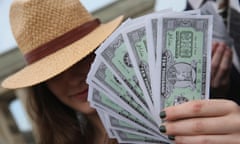 Activists Seek Transparency In Panama Papers Aftermath<br>BERLIN, GERMANY - APRIL 13: An activist wearing a Panama hat holds fake money while demanding greater trasparency in new legislation following the ongoing Panama Papers affair on April 13, 2016 in Berlin, Germany. Police in Panama have reportedly raided the offices of Mossack Fonseca, the law-firm accused of facilitating large-scale offshore tax evasion for thousands of its clients. (Photo by Sean Gallup/Getty Images)