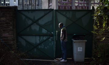 A migrant stands at the entrance of an abandoned house in Rennes, where migrants from the Democratic Republic of the Congo who seek asylum have been living