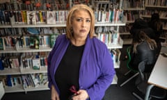 Zoe Thompson in a bright jacket and black top in school library