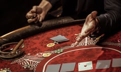 Emotional man in suit sitting at poker table and gesturing<br>HXGF1C Emotional man in suit sitting at poker table and gesturing