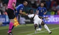 Italy's Giorgio Chiellini, left, stops England's Bukayo Saka during the Euro 2020 final. This would warrant a potential blue card.
