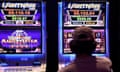 A person gambles on a poker machine at a pub.