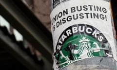 a sign reads "union busting is disgusting" over a Starbucks logo