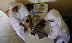 A nurse-midwife sorts out supplies with a colleague at their family planning clinic in Maiduguri, Nigeria.