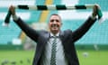 Brendan Rodgers holds a Celtic scarf during his unveiling as the club’s manager on Friday