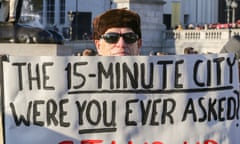 A protester in Oxford holding a sign reading: 'The 15-minute city. Were you ever asked?'