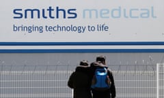 A couple outside Smiths Medical, a global manufacturer of specialty medical devices, in Tijuana, Mexico.