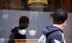 Designer face masks on display in a shirtmaker’s shop window in Manchester, UK