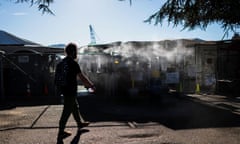 A man enters an encampment that has been outfitted with a misting station during a heatwave in Portland, Oregon, in August 2021.