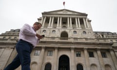 A man walks past the Bank of England in the City of London