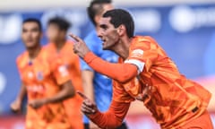 Shandong Luneng’s Marouane Fellaini celebrates after scoring one of three headers against Dalian Pro on Sunday.