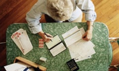 An elderly woman doing her accounts