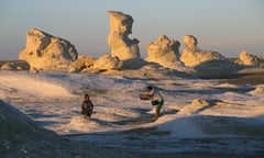 Tourists pose for photos with the massive white inselbergs that are characteristic of Egypt’s White desert