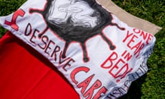 A pillow bearing the slogans ‘I deserve care’ and ‘One year in bed!’