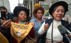 Three women, moved to tears, are interviewed by the press outside a court building in Lima.