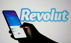 Woman holds smartphone with Revolut app