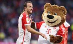 Harry Kane is congratulated by the Bayern mascot after his two goals. 