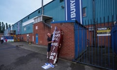 A fan places a scarf on a coffin outside Bury’s Giggs Lane stadium in late August.