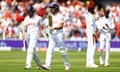 Jimmy Anderson (second left) and Jamie Smith head to the pavilion after debutant Smith was out for 70 to end England’s innings.