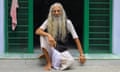 A 72-year-old man sits in a mosque entranceway