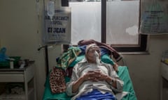 A man affected by lung cancer lays on his bed inside one of the rooms at the Bhaktapur Cancer Hospital in Nepal.