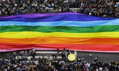 Revellers extend a flag during the annual gay pride parade in São Paulo, Brazil
