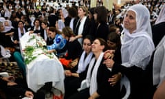 Women mourn by a coffin during a funeral of a person killed in a rocket strike from Lebanon a day earlier.