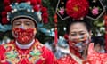 Close-up on two revellers in traditional Chinese costume celebrating the lunar new year