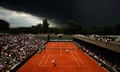 Dark clouds loom over court 2 during the men’s doubles second round match between Sam Groth of Australia and Robert Lindstedt of Sweden and the US’s Bob and Mike Bryan.