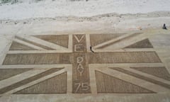 A giant union flag drawn into the sand at Bamburgh Castle in Northumberland to mark the VE Day anniversary