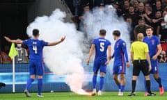A flare is thrown on the pitch during England’s win in Hungary which was marred by abuse from the home crowd